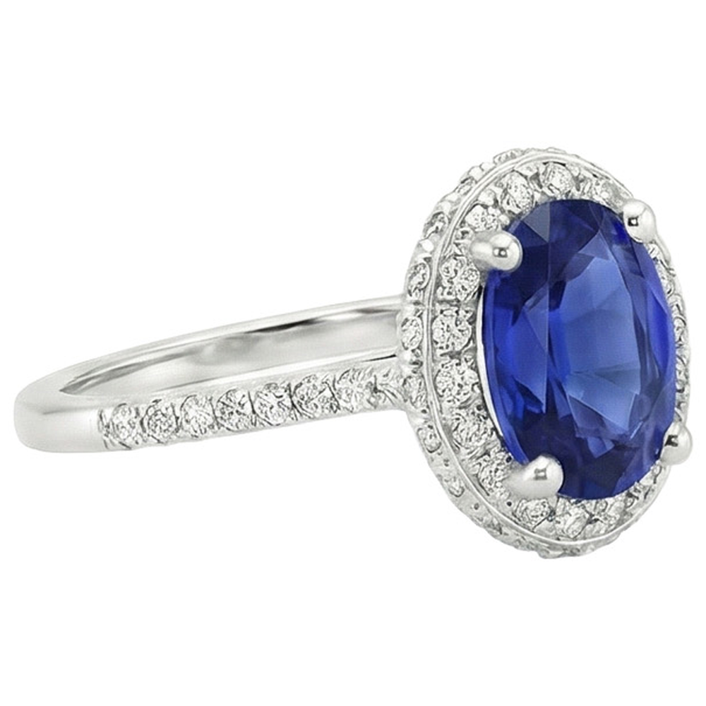 Anello Halo con zaffiro blu taglio ovale 3,75 carati e pavé di diamanti in oro bianco 14K