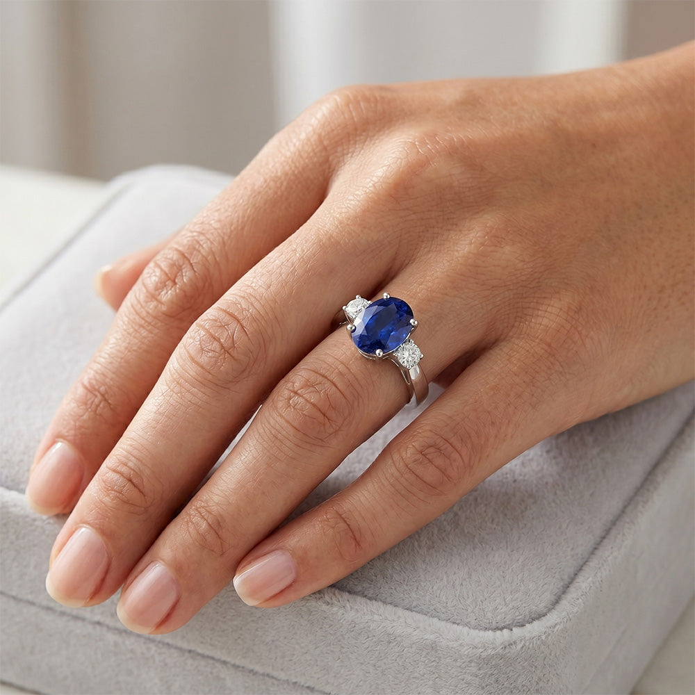 Anello con 3 pietre. zaffiro blu ovale e diamante. gambo affusolato da 4.75 carati