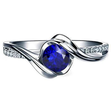 Anello in oro bianco 14K e diamanti con zaffiro tondo. 1,50 carati. stelo intrecciato