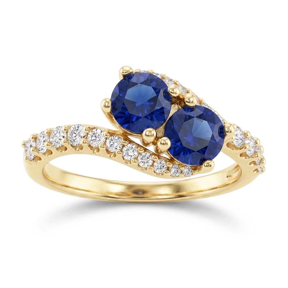 Anello con diamante tondo 2,50 carati e zaffiro blu con gambo intrecciato in oro 14K