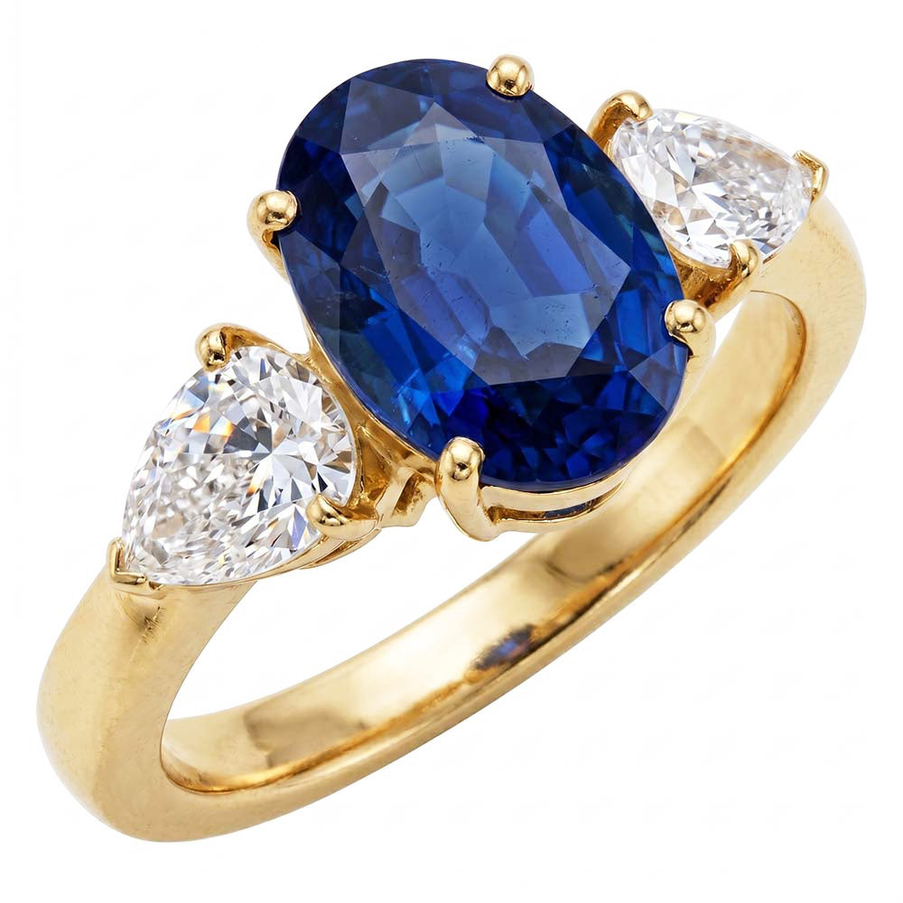 Anello in oro giallo con zaffiro blu ovale e diamante a pera 3 pietre 5.25 carati