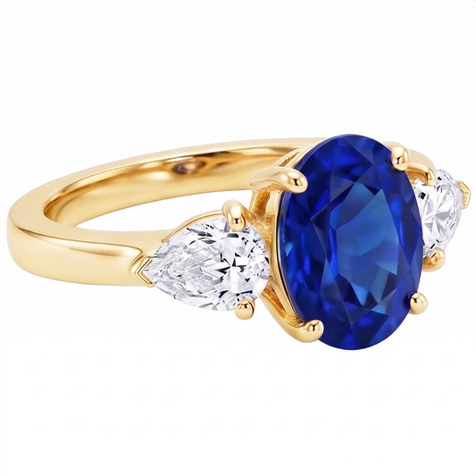 Anello in oro giallo con zaffiro blu ovale e diamante a pera 3 pietre 5.25 carati