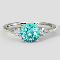 Anello rotondo con tormalina Paraiba e tre pietre