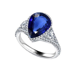 Anello Halo con castone con accenti di pera blu zaffiro da 4 carati e diamanti
