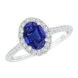 Anello Halo con diamante ovale. zaffiro blu accentato. oro bianco 5.50 carati