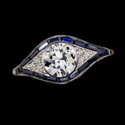 Anello con castone rotondo con diamanti taglio antico e zaffiro baguette 3 carati