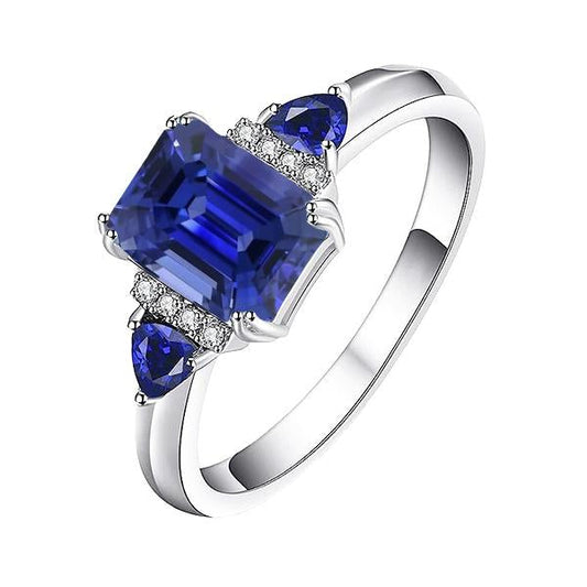 Anello con tre pietre di smeraldo e zaffiro blu naturale e diamanti 3 carati - harrychadent.it
