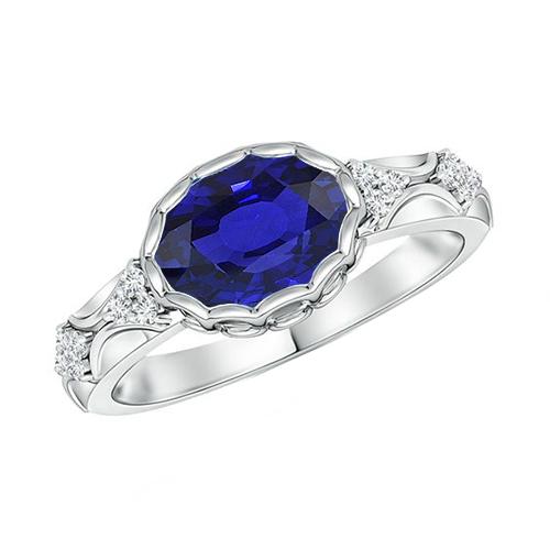 Anello in oro bianco con diamanti da donna. lunetta con zaffiro blu ovale. 3.75 carati - harrychadent.it