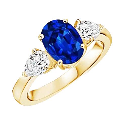 Anello in oro giallo con zaffiro blu ovale e diamante a pera 3 pietre 5.25 carati - harrychadent.it