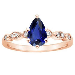 Anello in oro rosa con zaffiro stile vintage pera e diamanti tondi 4 carati
