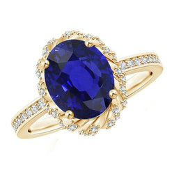 Anello ovale con gemma aureola blu zaffiro pavé di diamanti oro giallo 7 carati